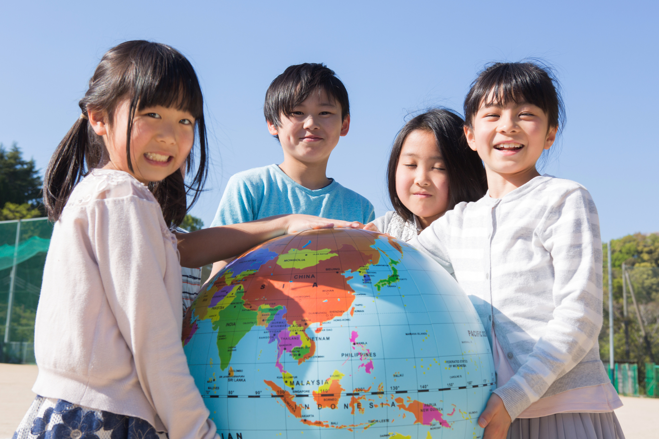 Elementary school students with globe